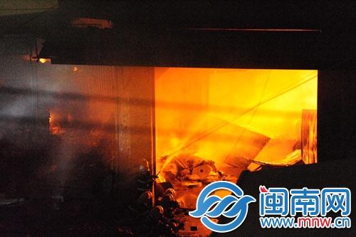 倉庫火勢很旺，消防員用水槍壓制